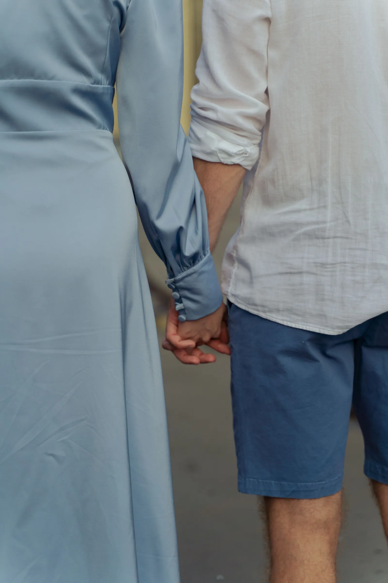 A couple holding hands, representing romantic love, commitment, and faithful companionship